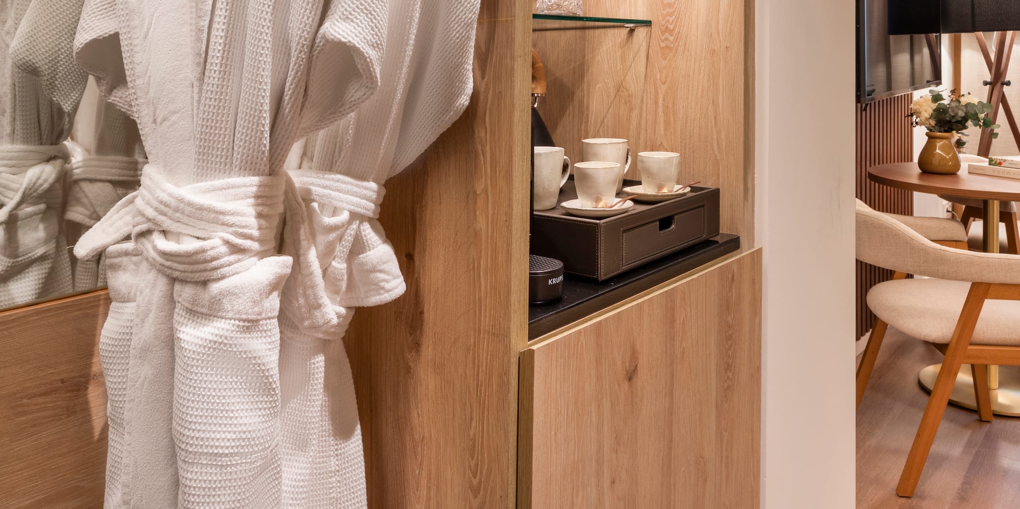 a white robe on a rack in a room