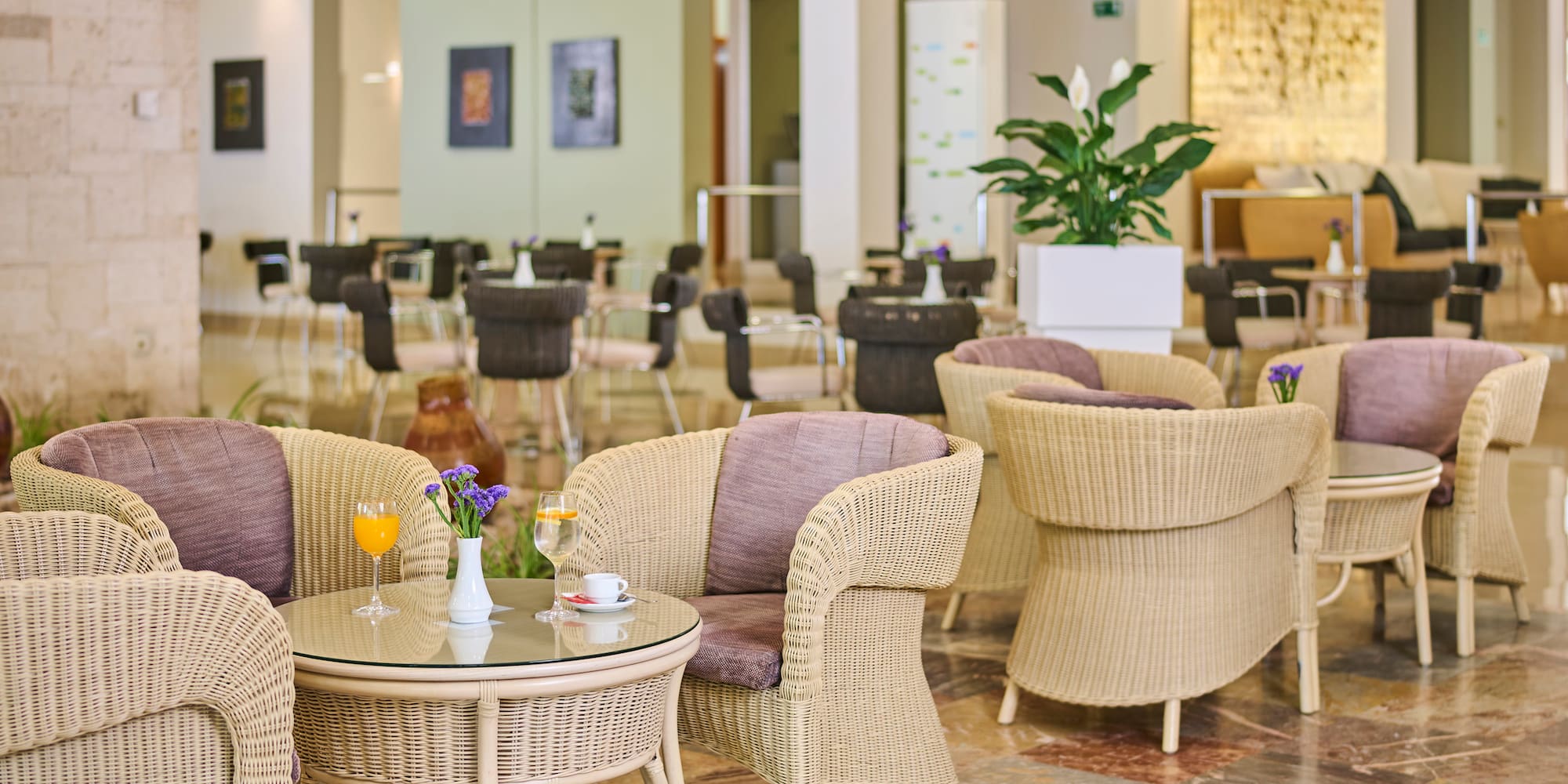 a room with wicker chairs and tables