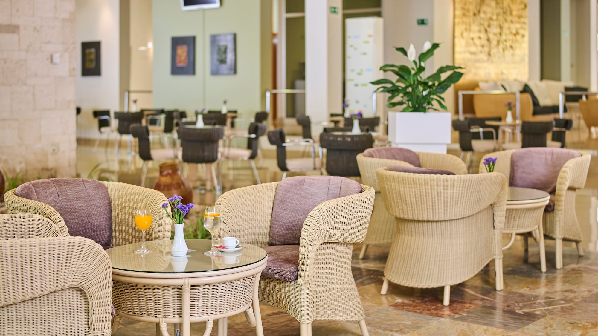 a room with wicker chairs and tables