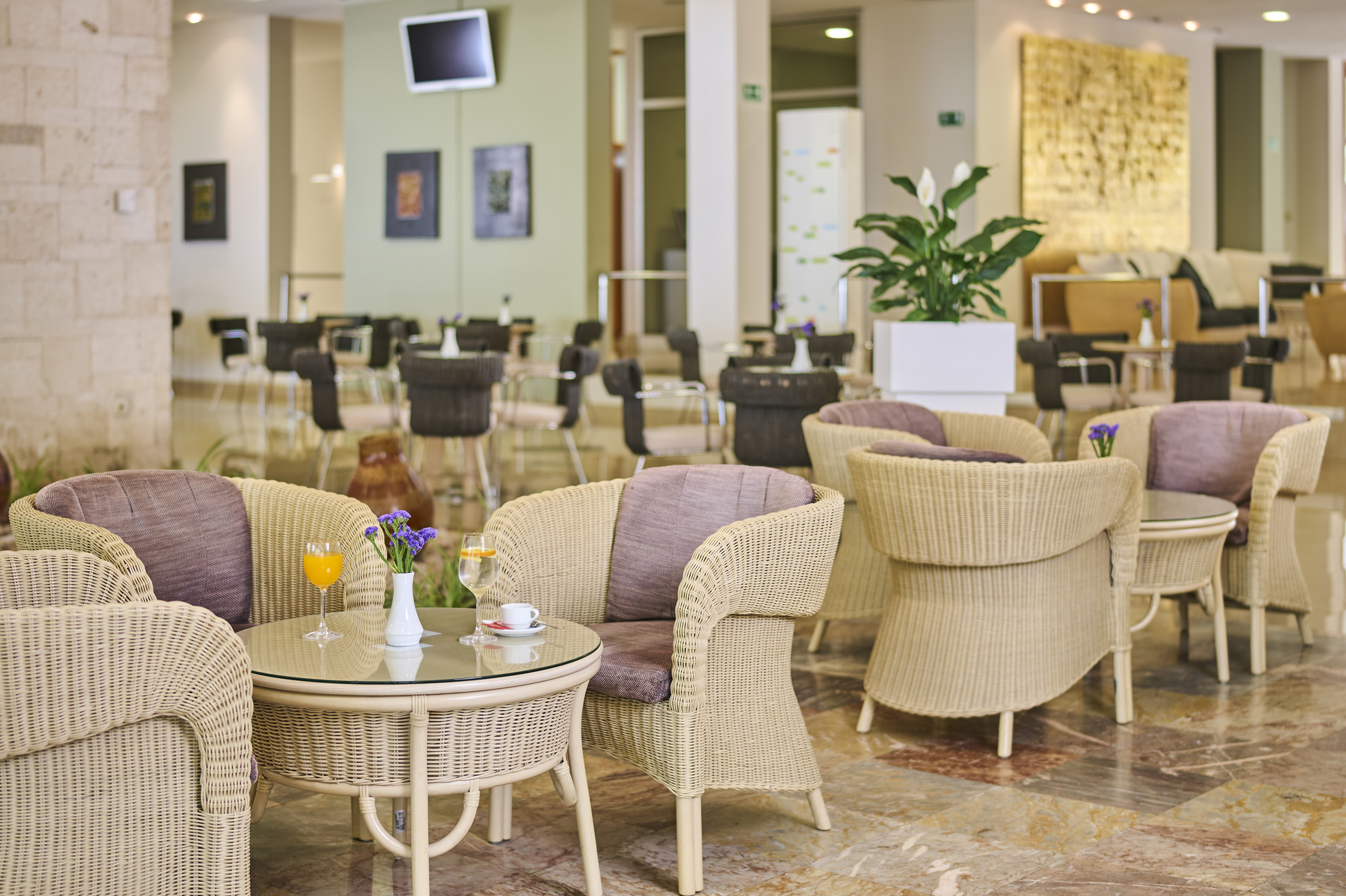 a room with wicker chairs and tables