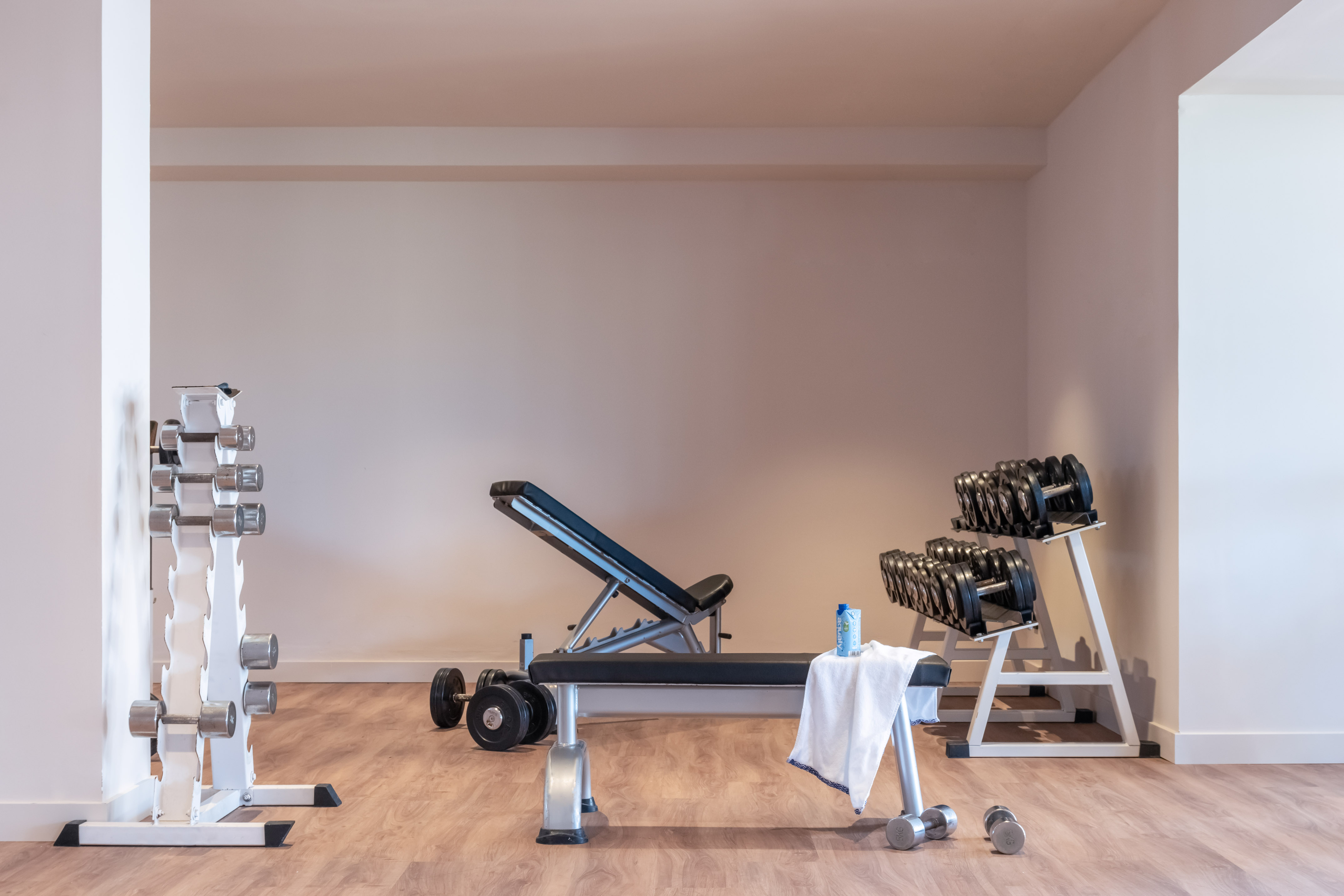 a room with weights and a bench