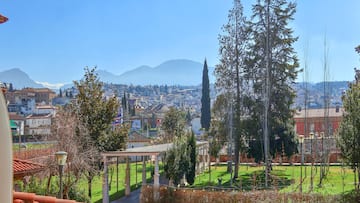 a park with trees and a building in the background