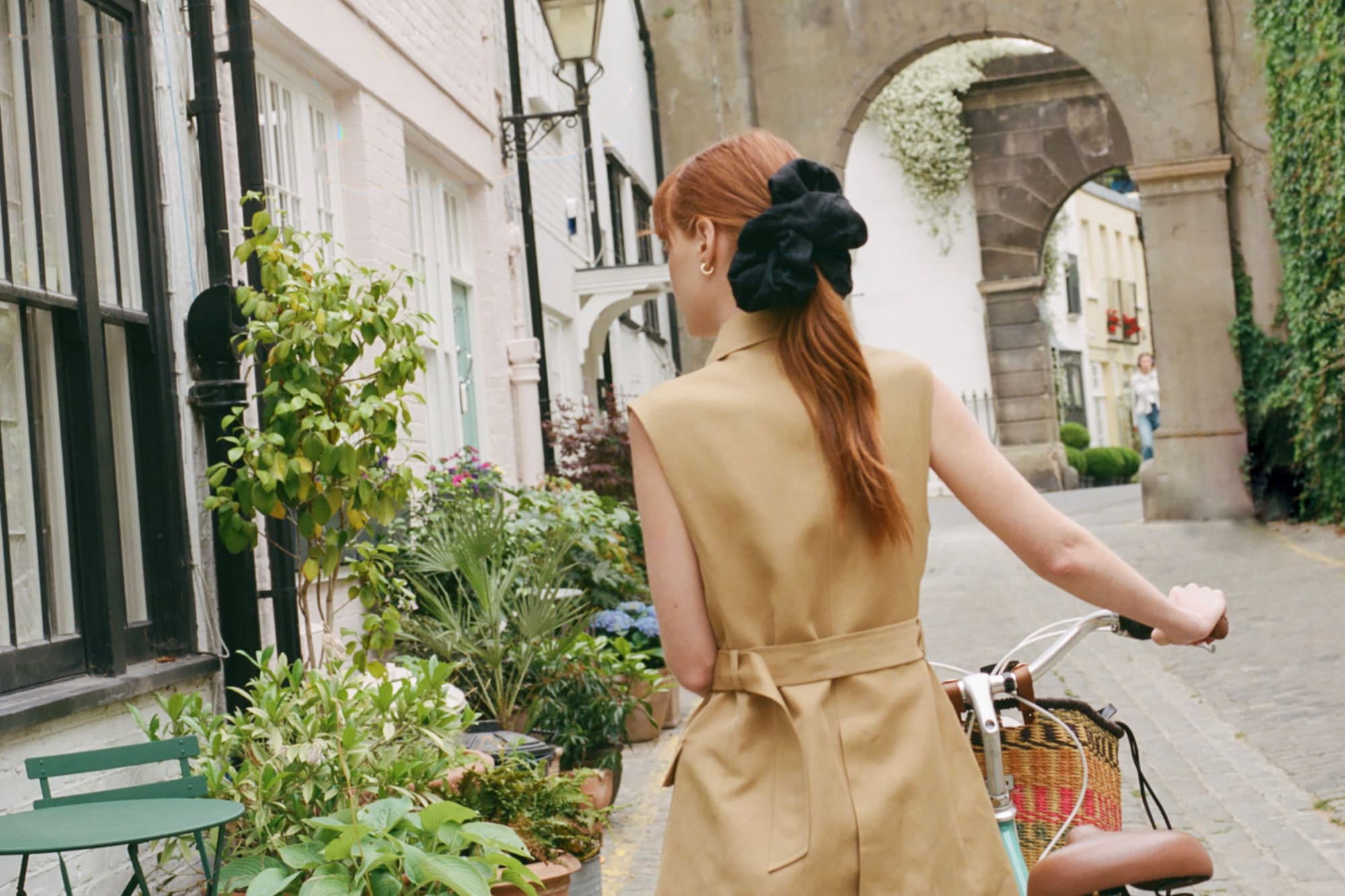 a woman with a bicycle on a street