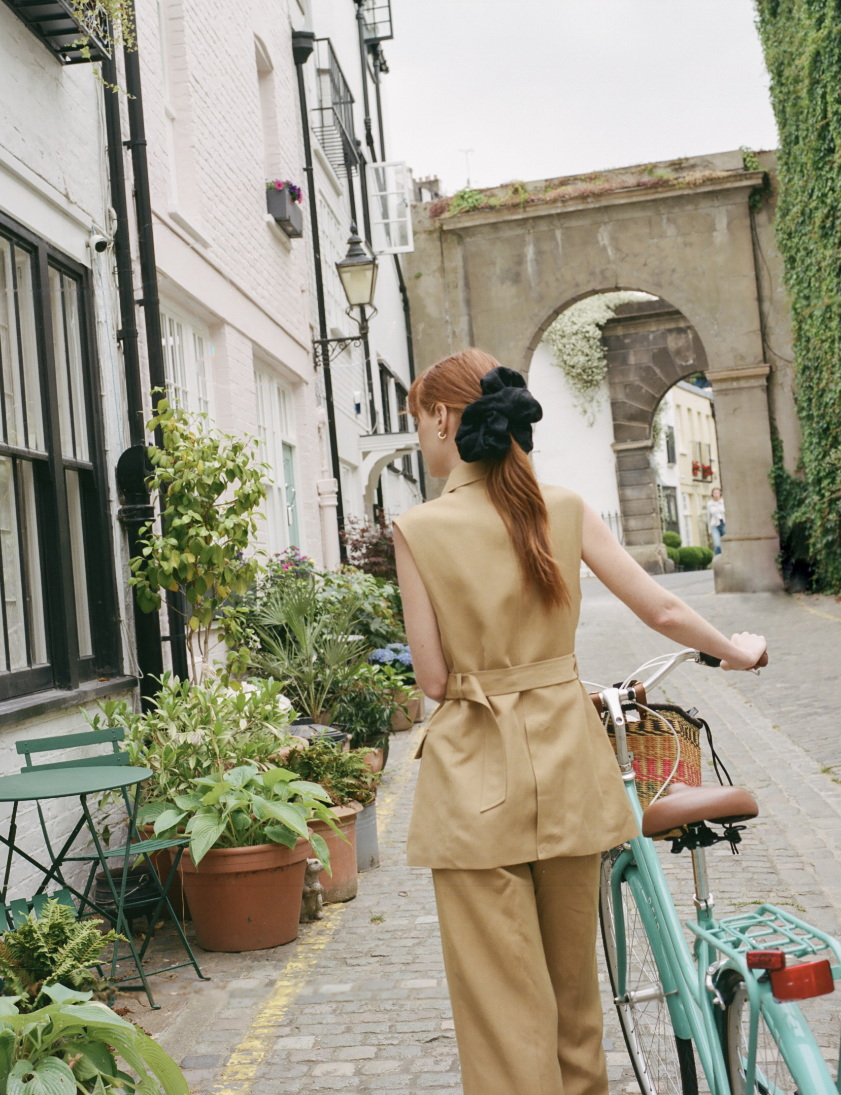 a woman with a bicycle on a street