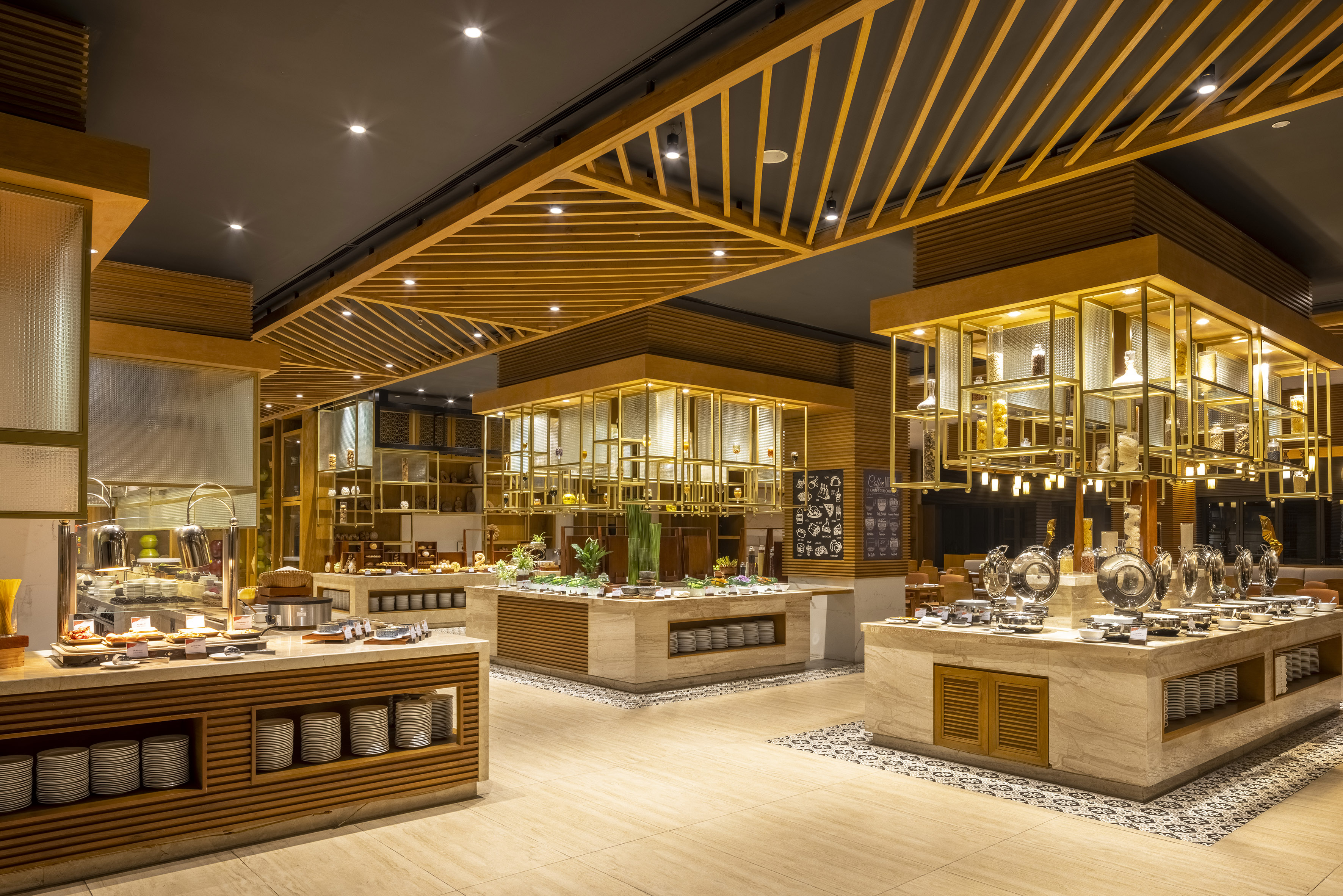 Modern restaurant buffet with elegant food stations and warm lighting.