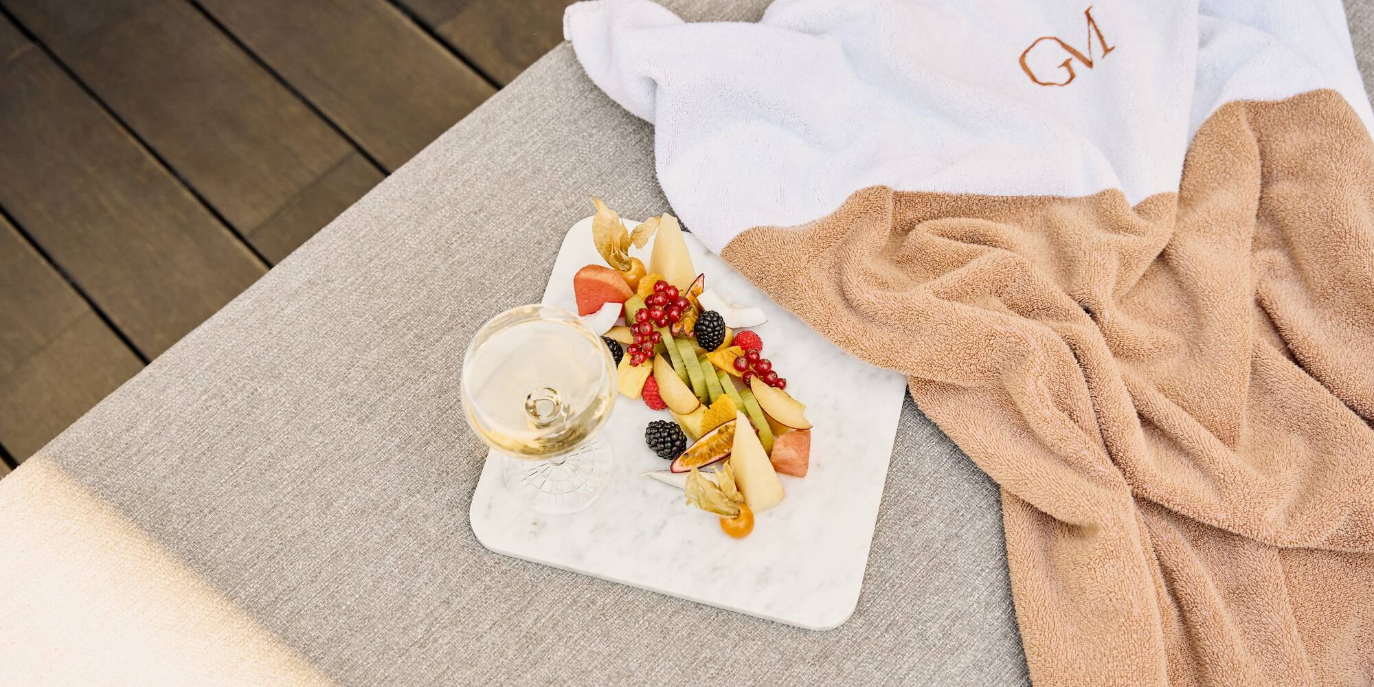 a plate of fruit and a glass of wine