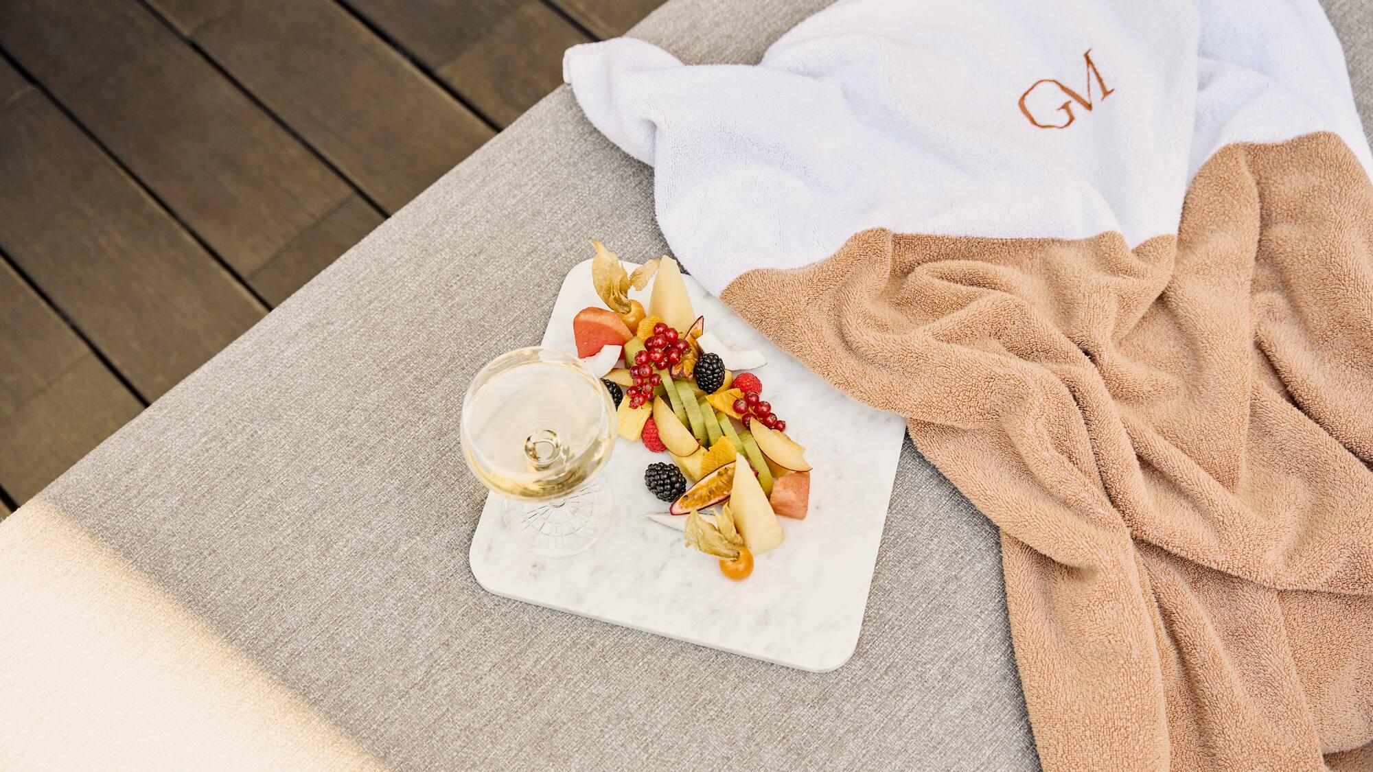 a plate of fruit and a glass of wine