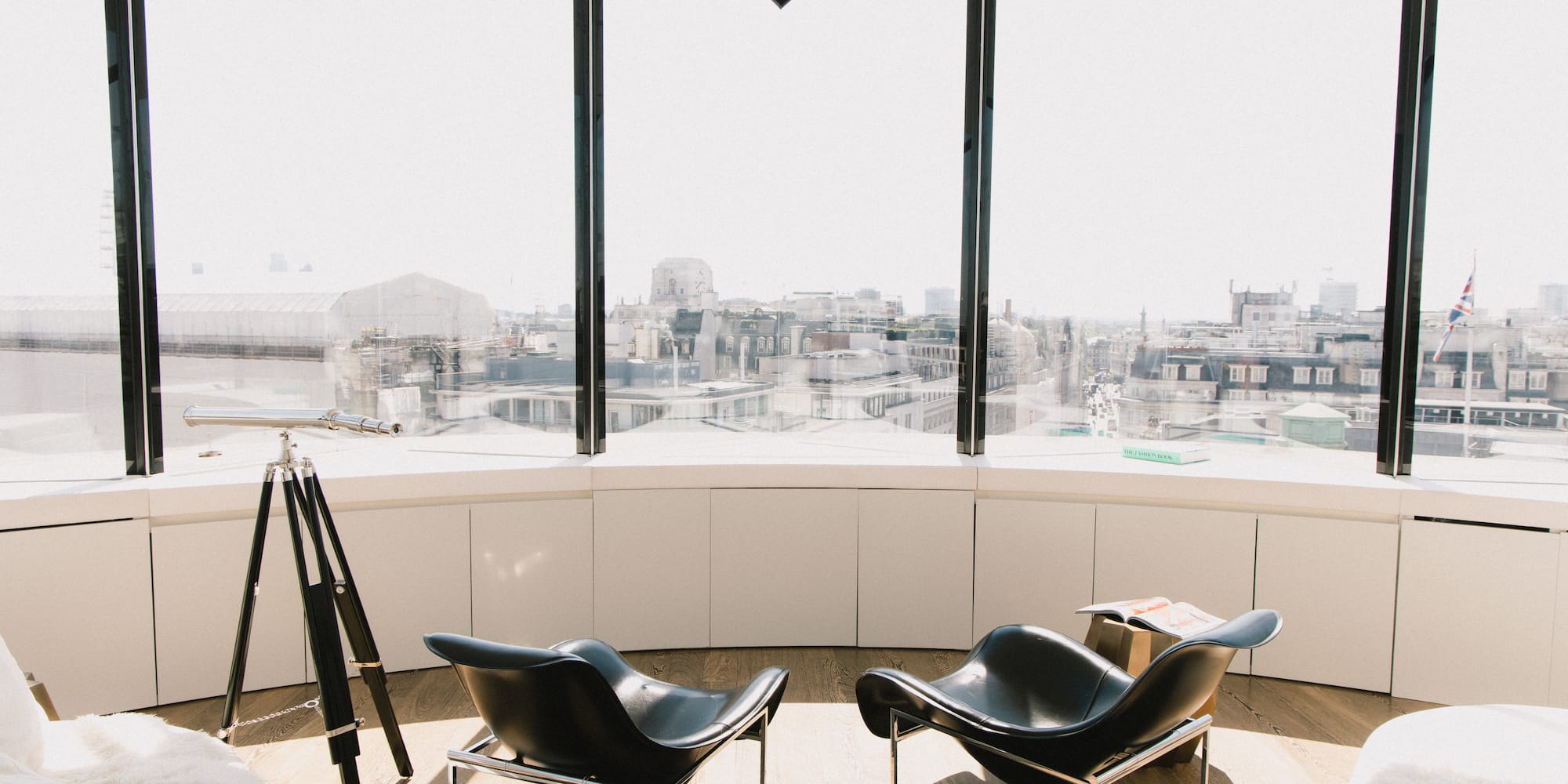 a room with a large window and chairs
