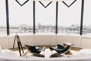 a room with a large window and chairs