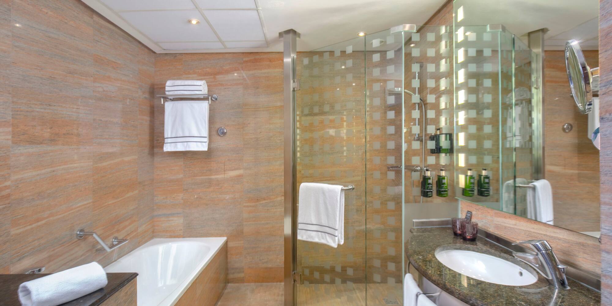 a bathroom with a glass shower and tub