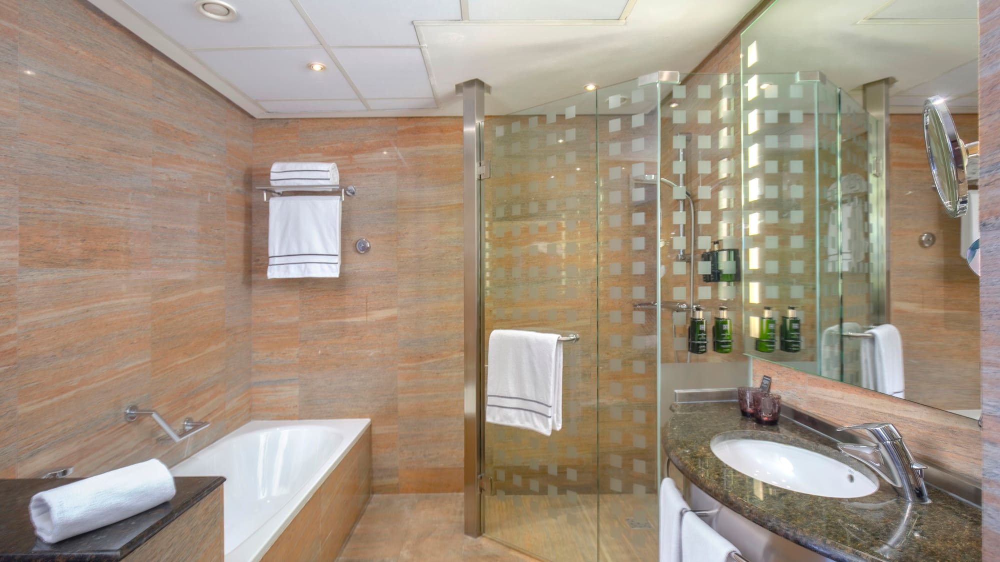 a bathroom with a glass shower and tub