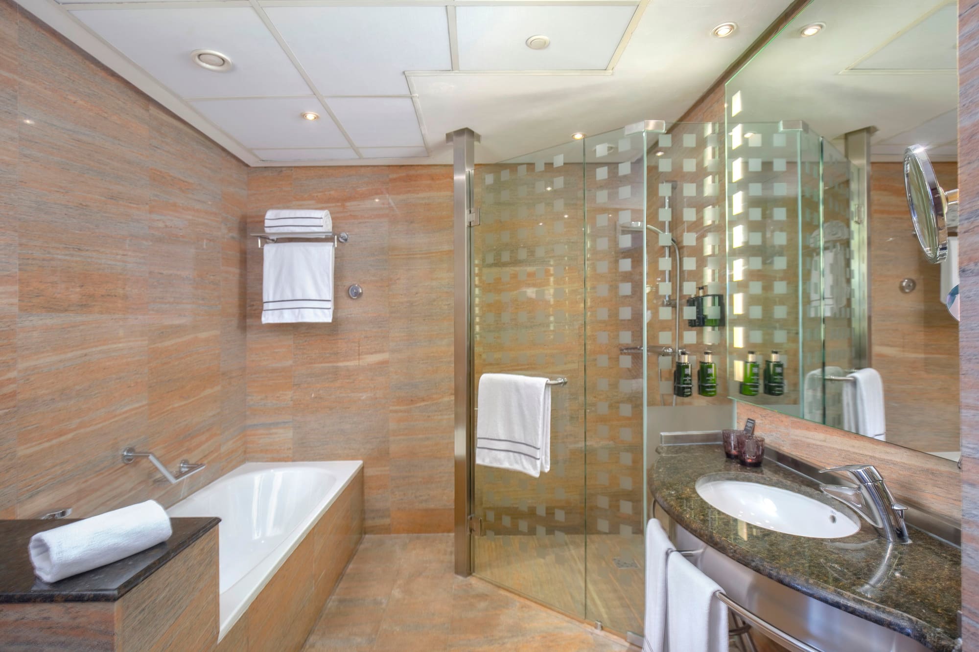 a bathroom with a glass shower and tub