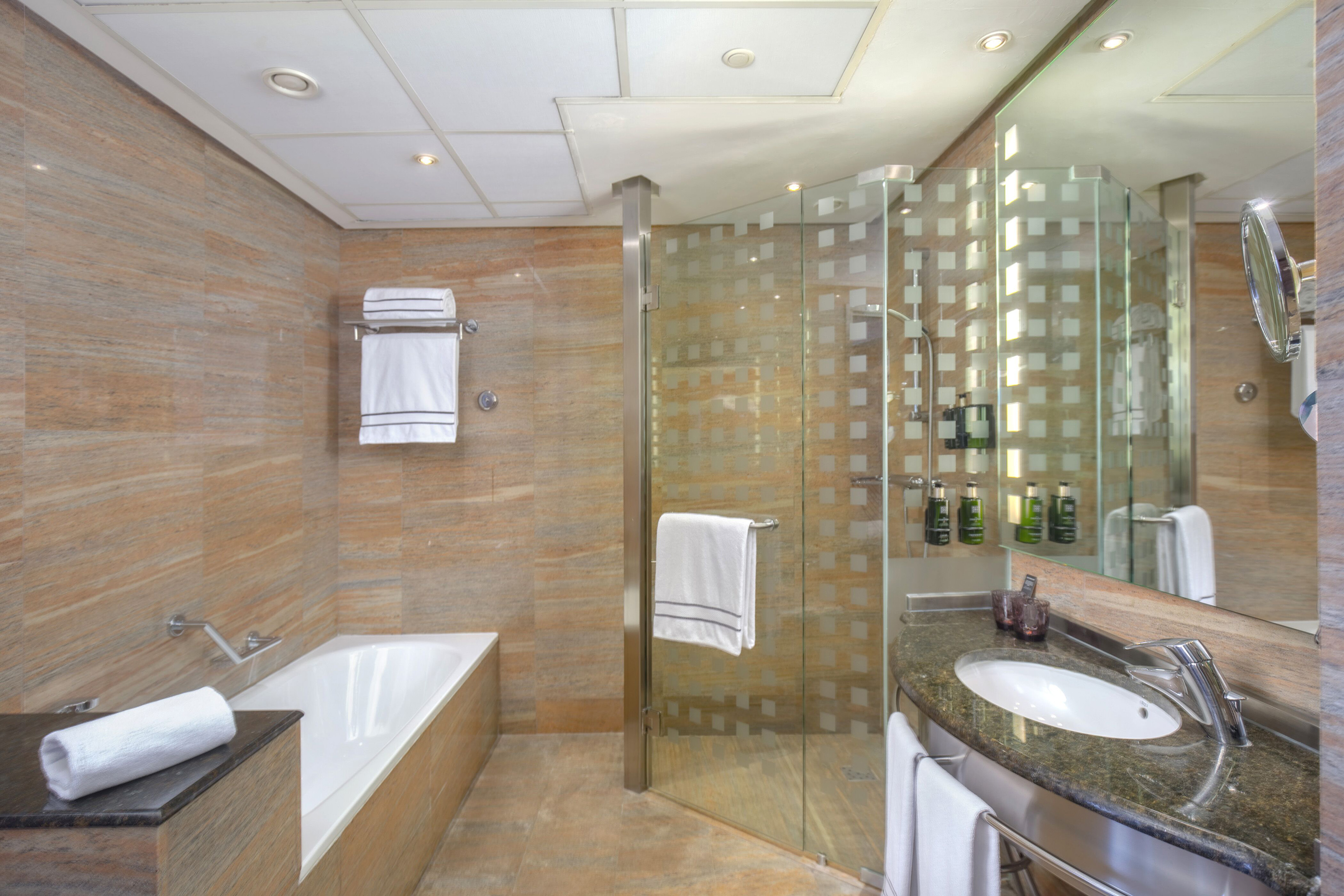a bathroom with a glass shower and tub