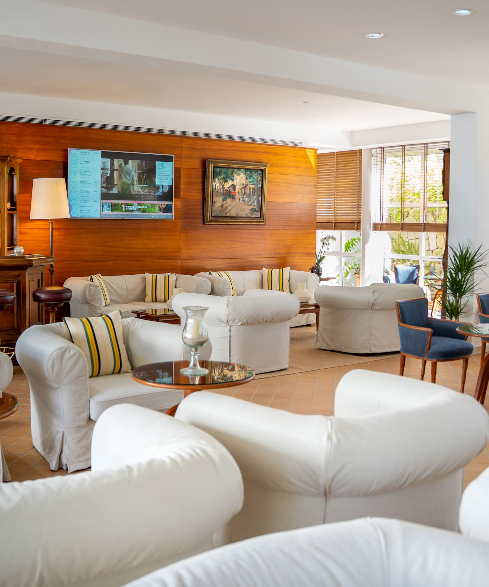 a room with white furniture and tables