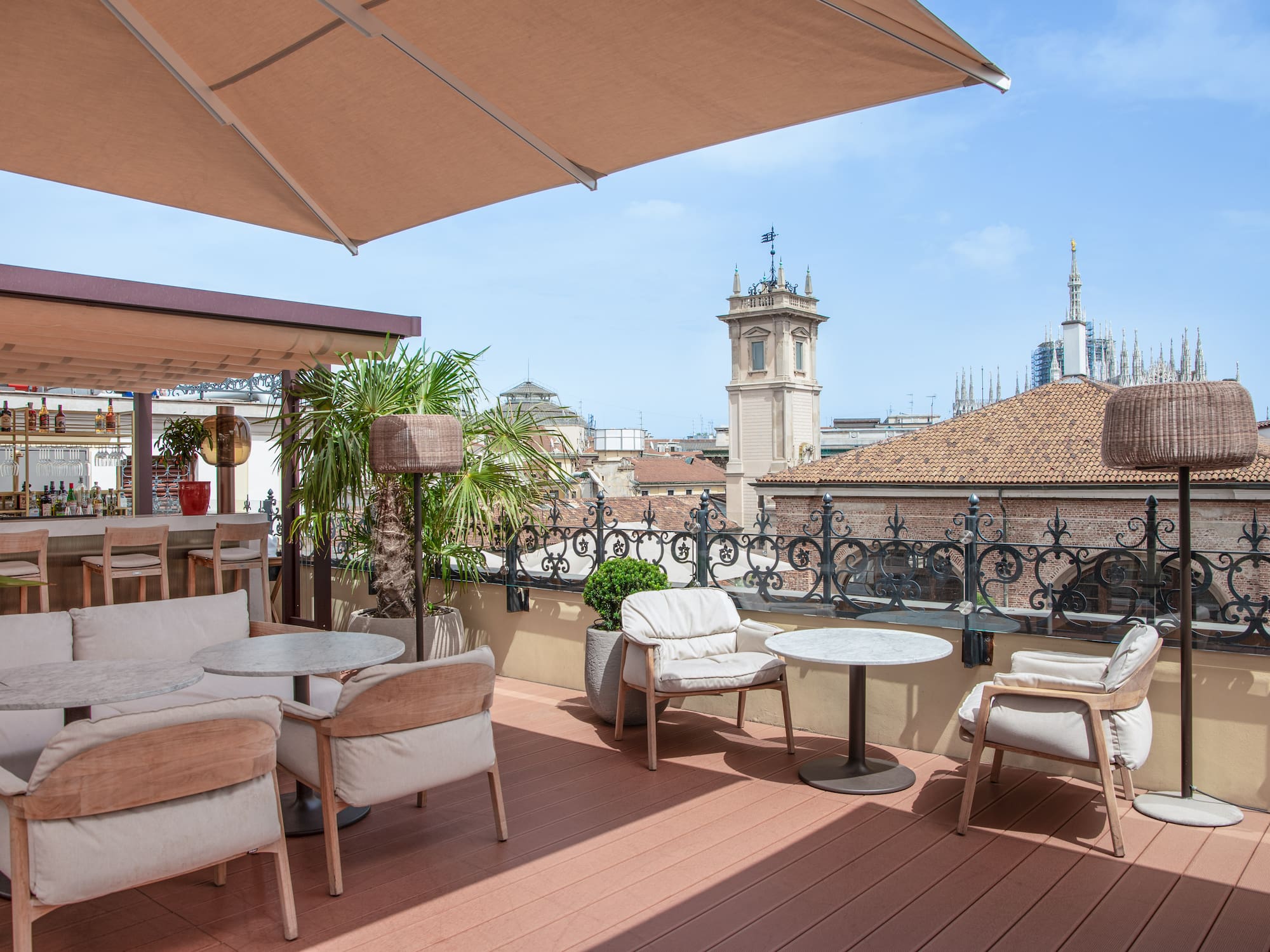 Milan city views from the Isola rooftop with chairs and tables at the Palazzo Cordusio Gran Melia