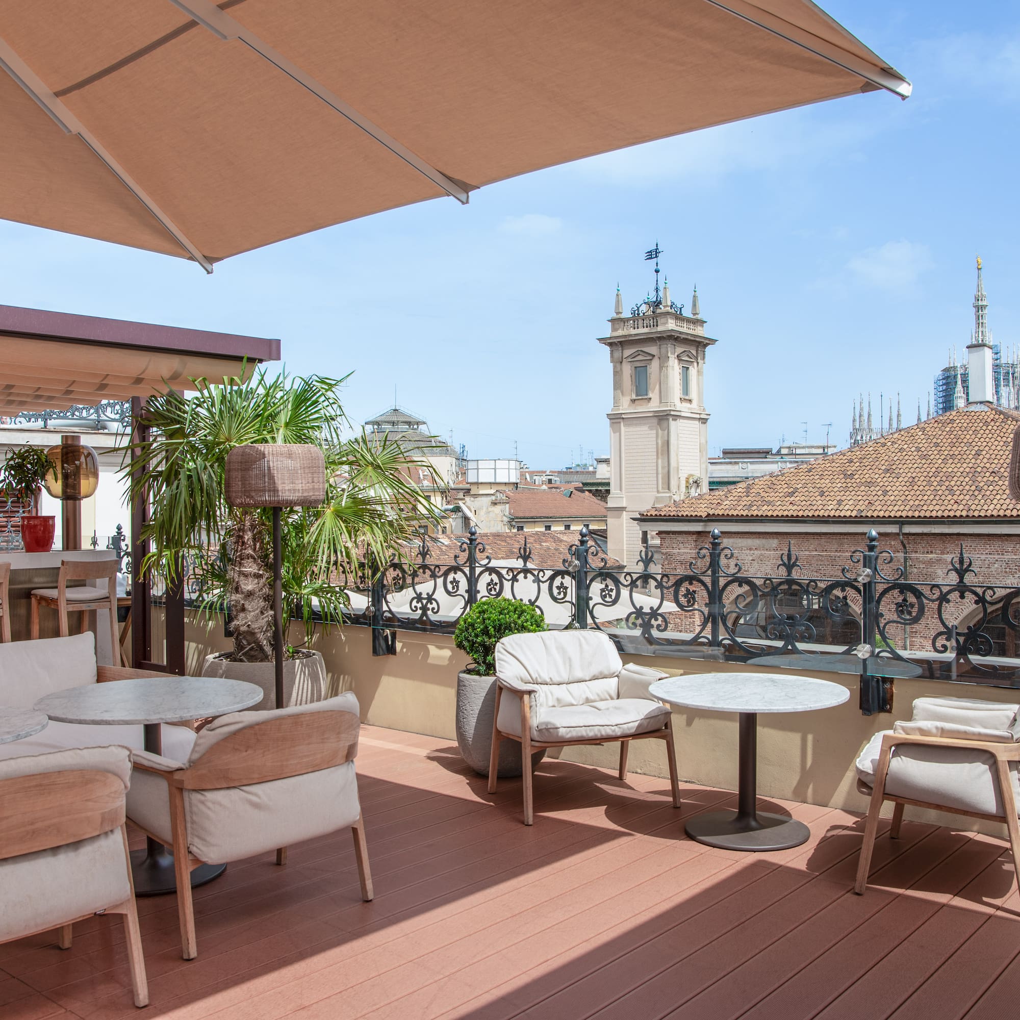 Milan city views from the Isola rooftop with chairs and tables at the Palazzo Cordusio Gran Melia