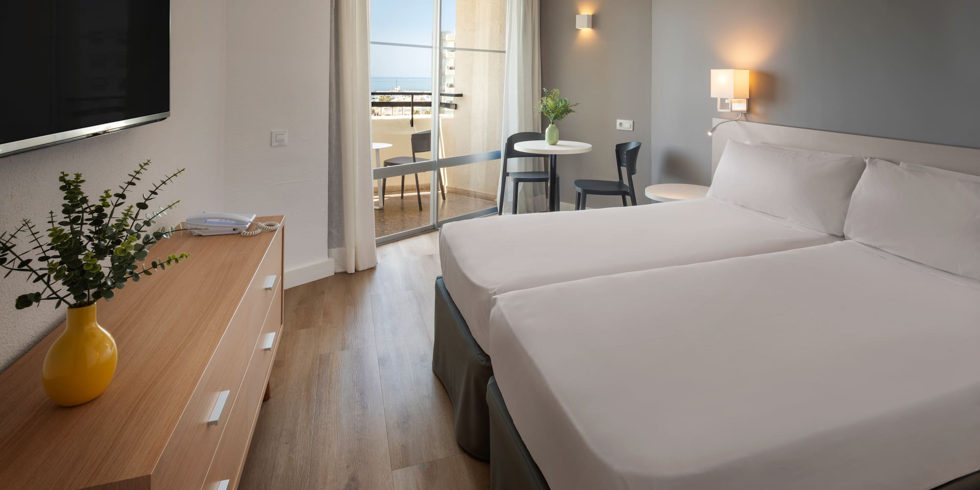 a room with two beds and a television