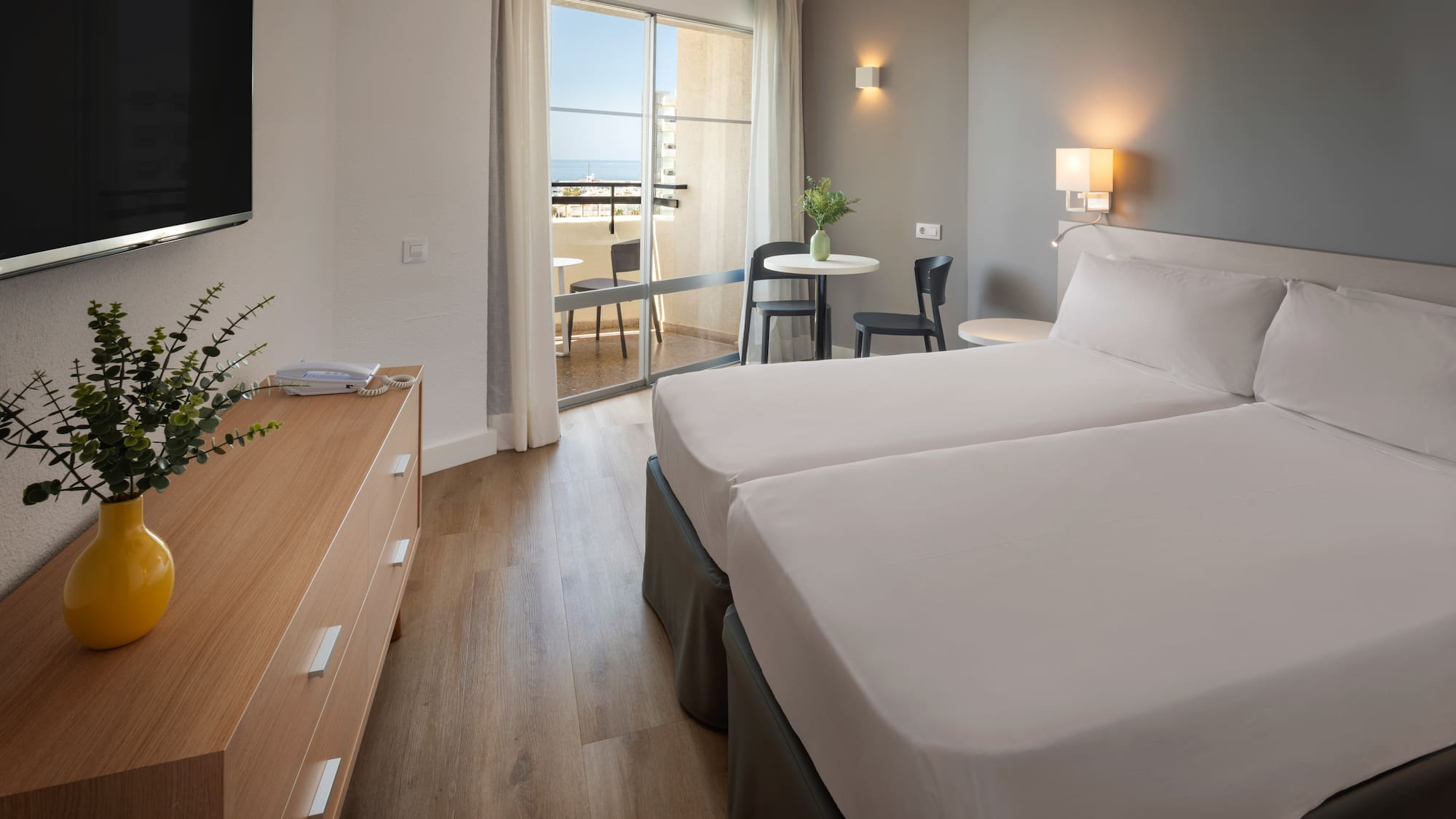 a room with two beds and a television