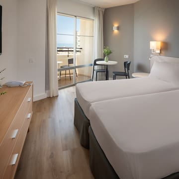 a room with two beds and a television