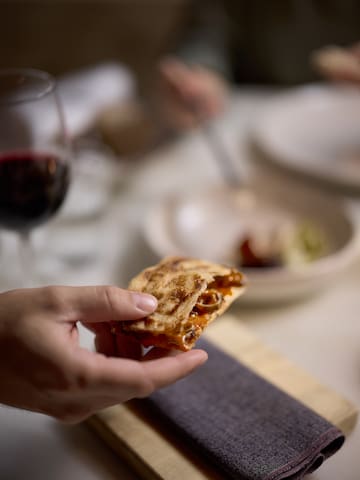 a hand holding a piece of food