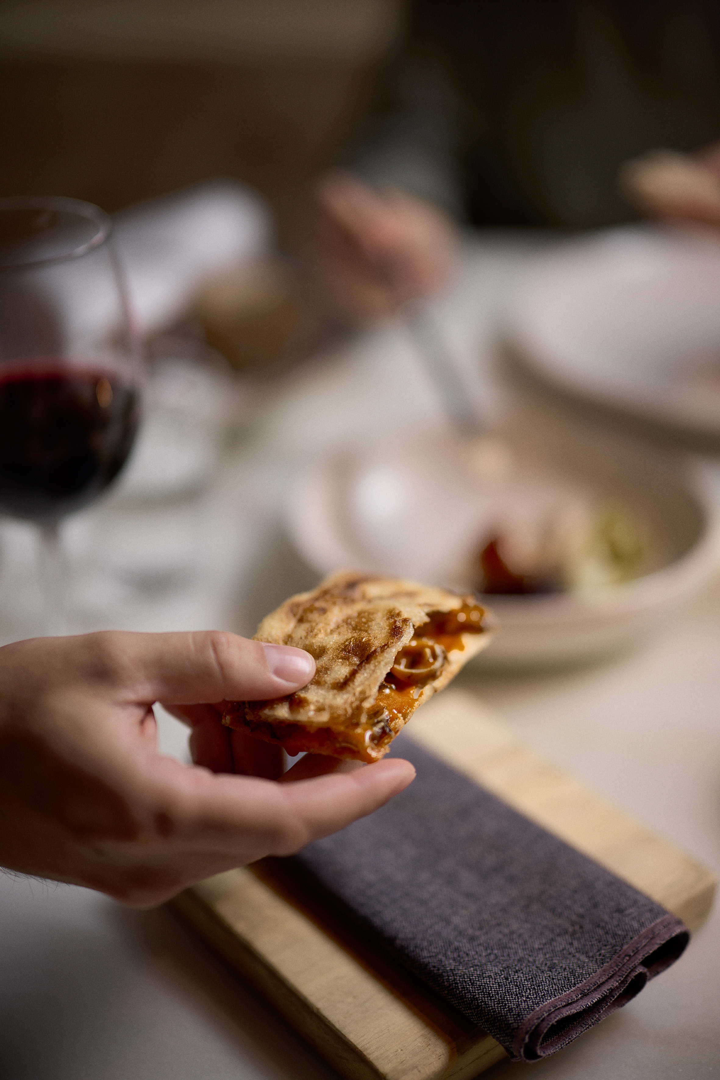 a hand holding a piece of food