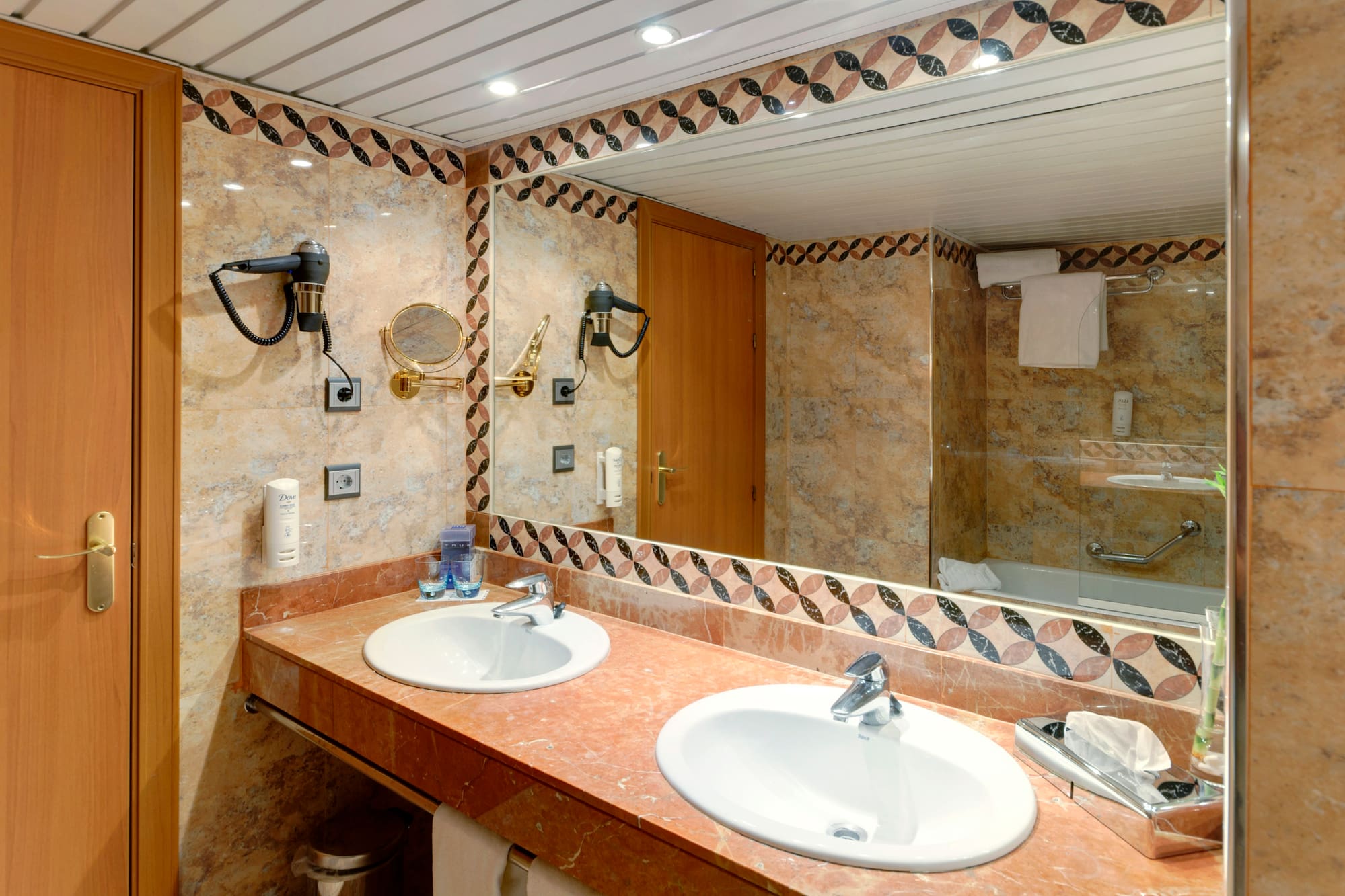 a bathroom with marble counter tops and a mirror