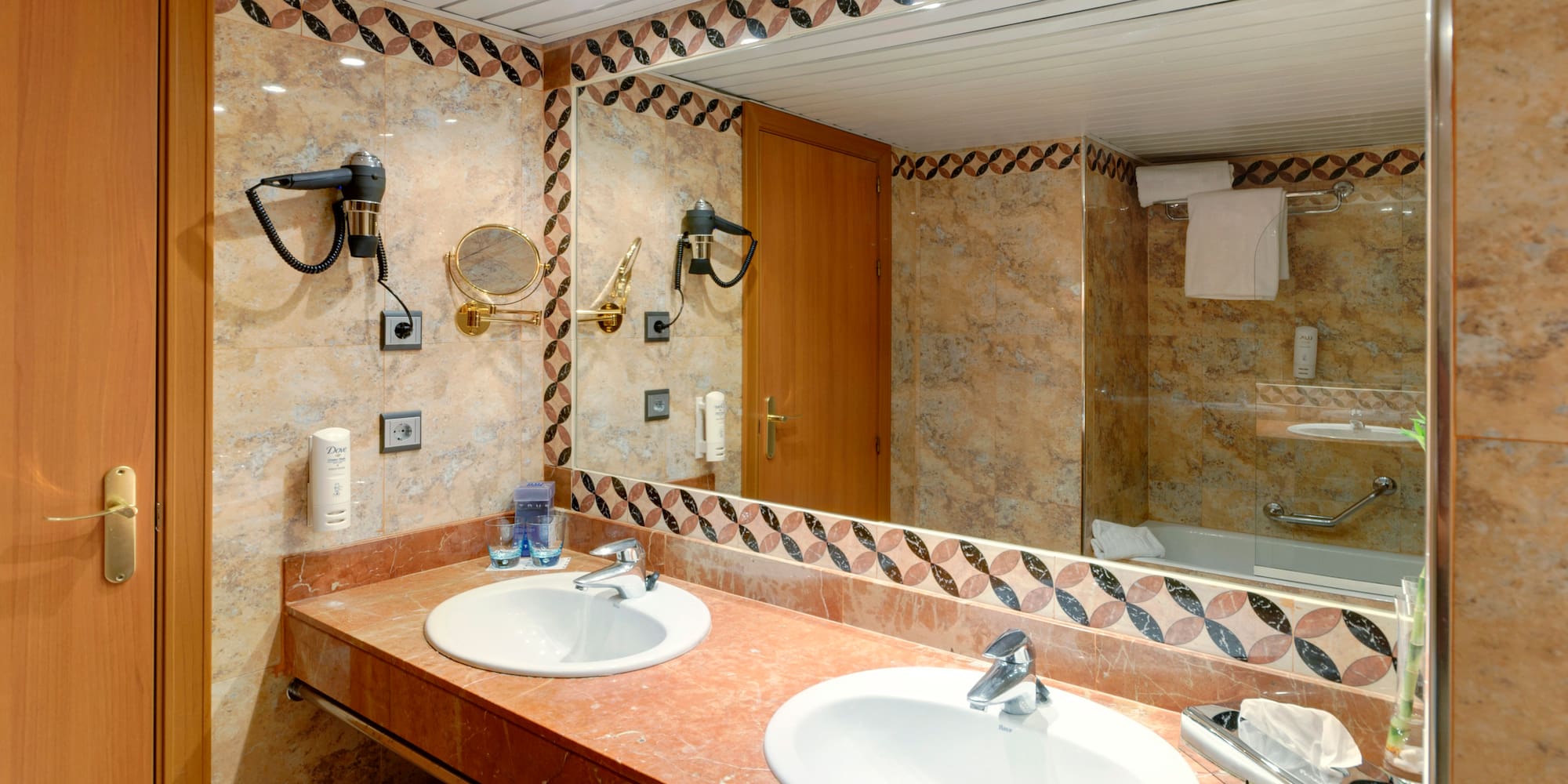 a bathroom with marble counter tops and a mirror
