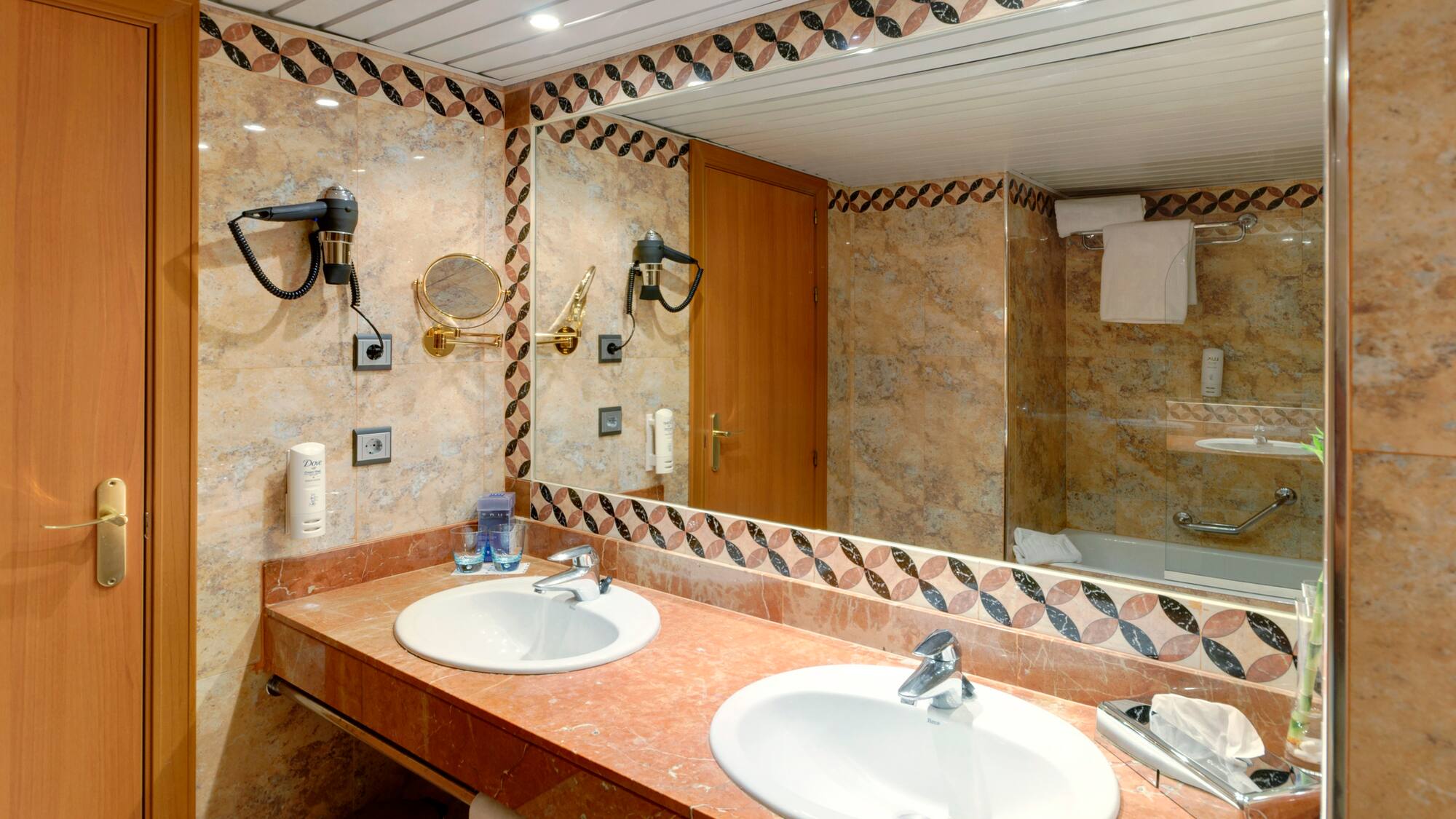 a bathroom with marble counter tops and a mirror
