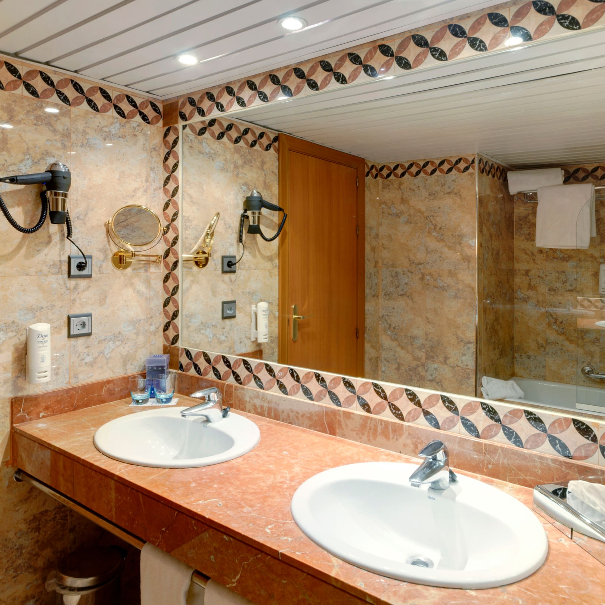 a bathroom with marble counter tops and a mirror