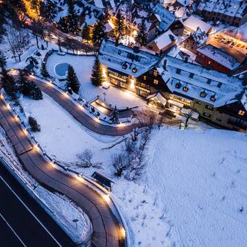a road and buildings with lights and snow