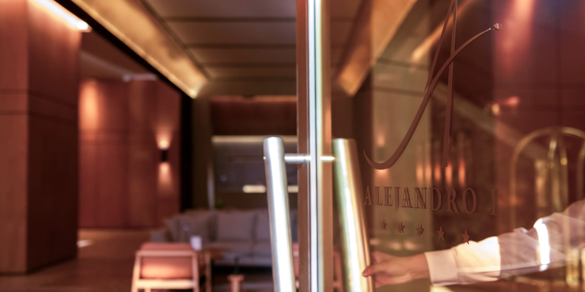 a person opening a glass door