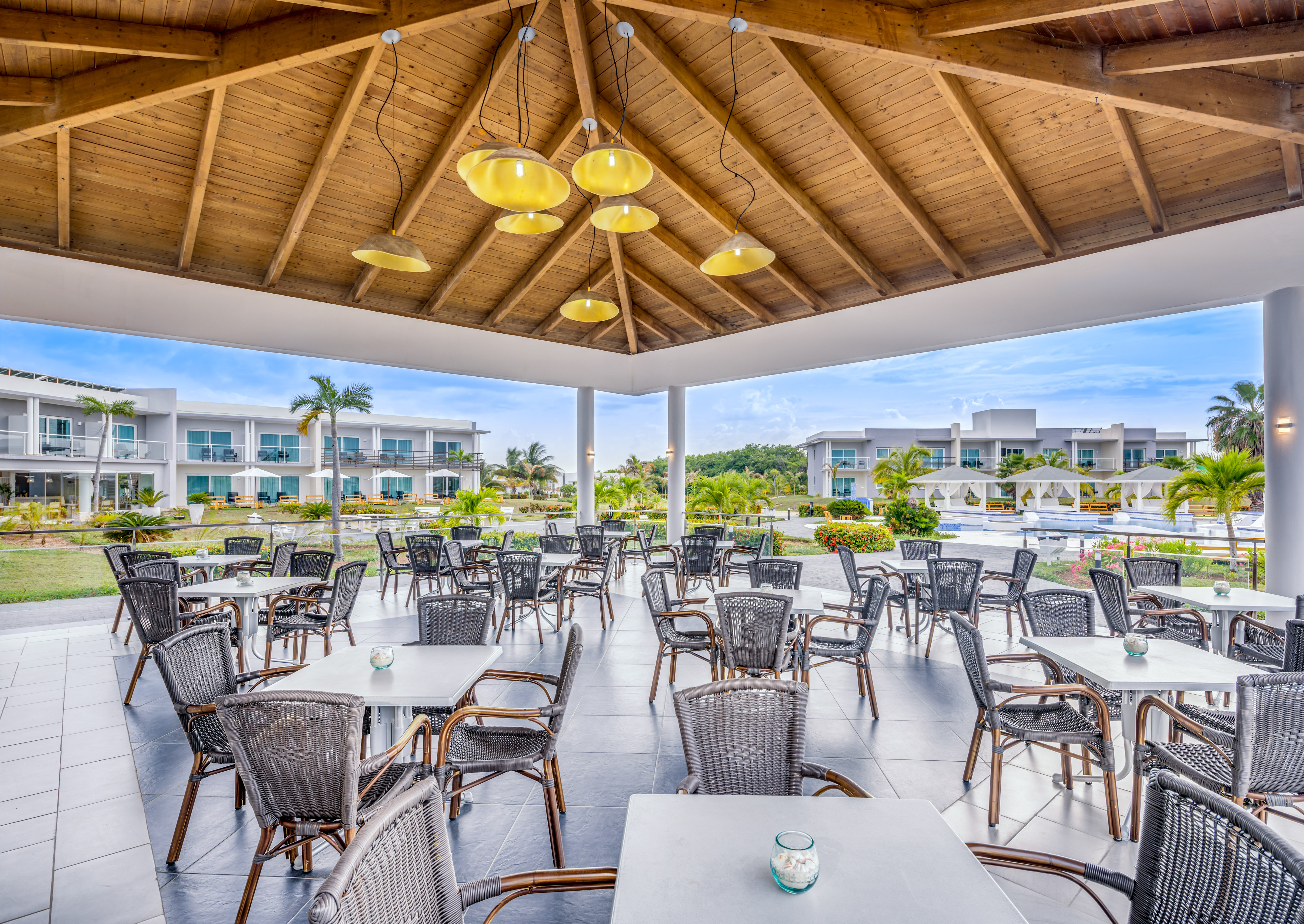 a patio area with tables and chairs