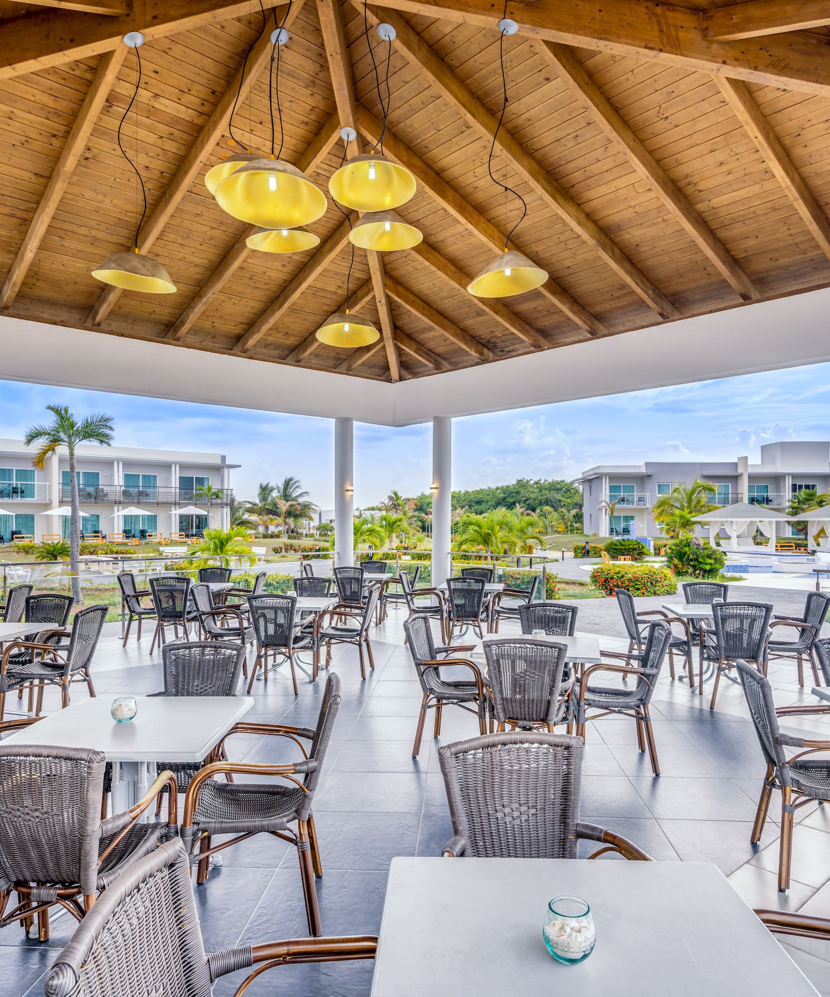 a patio area with tables and chairs