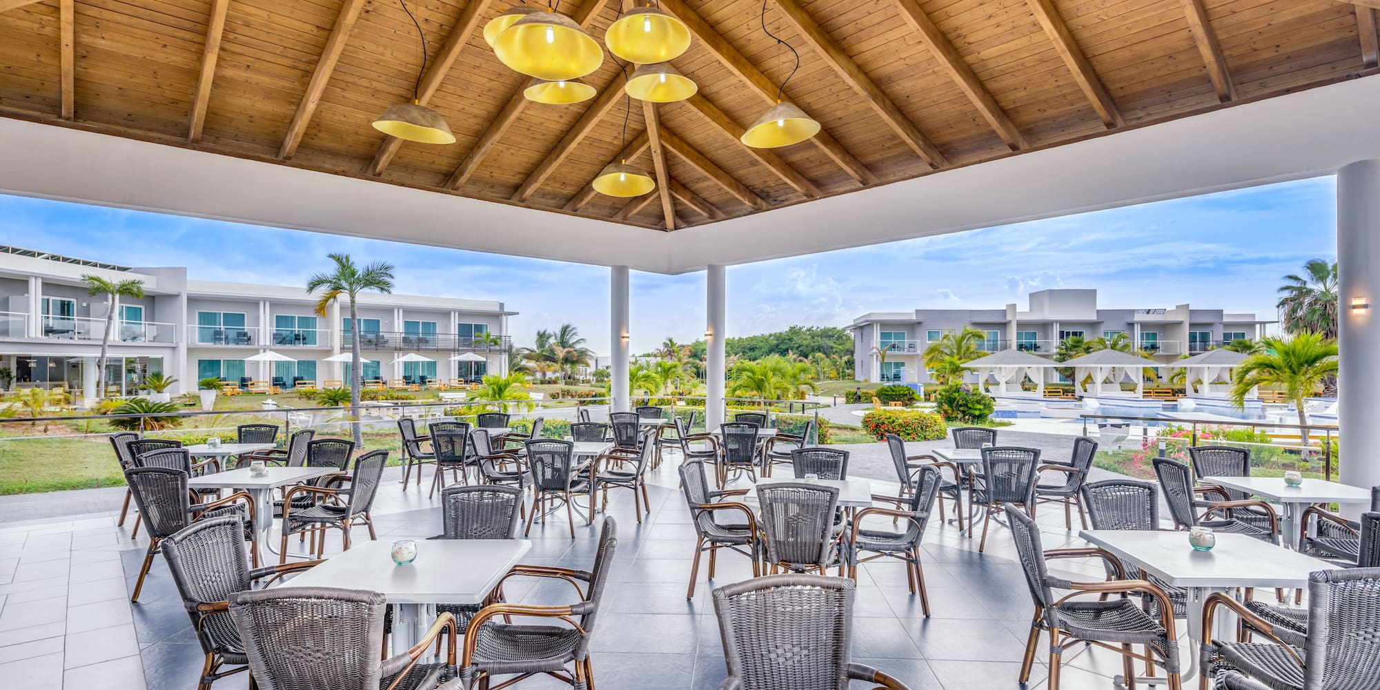 a patio area with tables and chairs