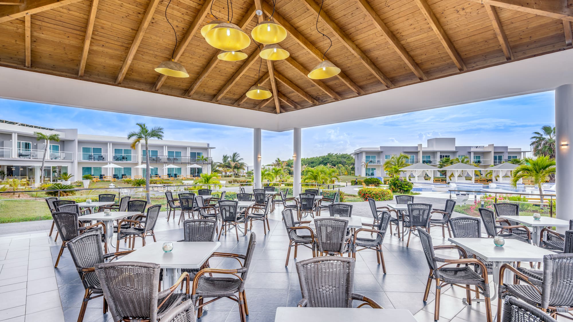 a patio area with tables and chairs