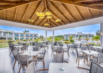 a patio area with tables and chairs