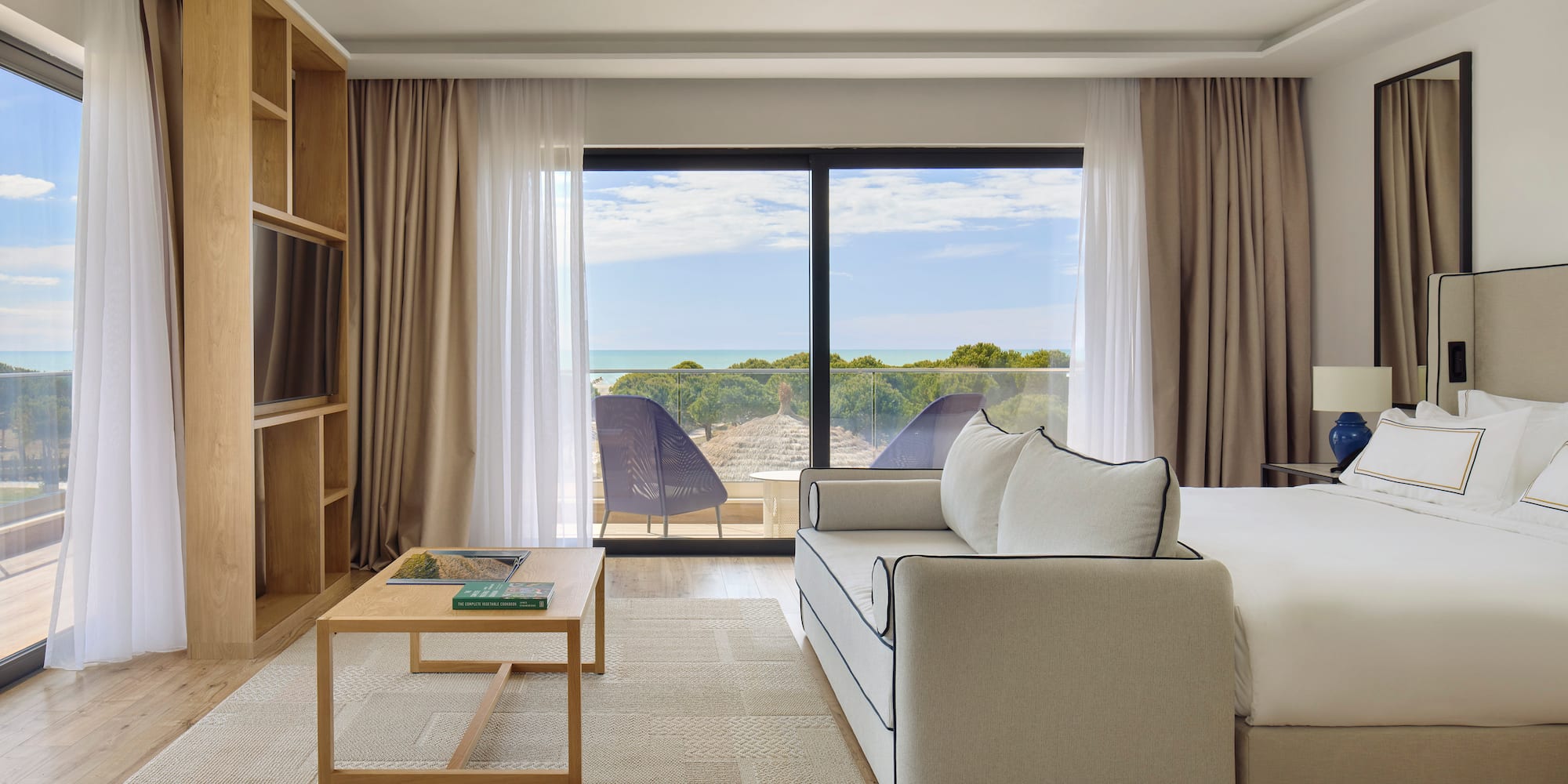 a room with a bed and a television