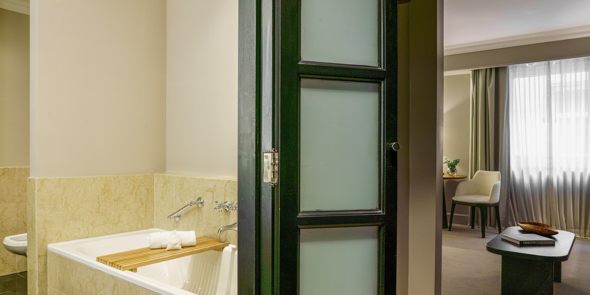 a bathroom with a tub and a chair