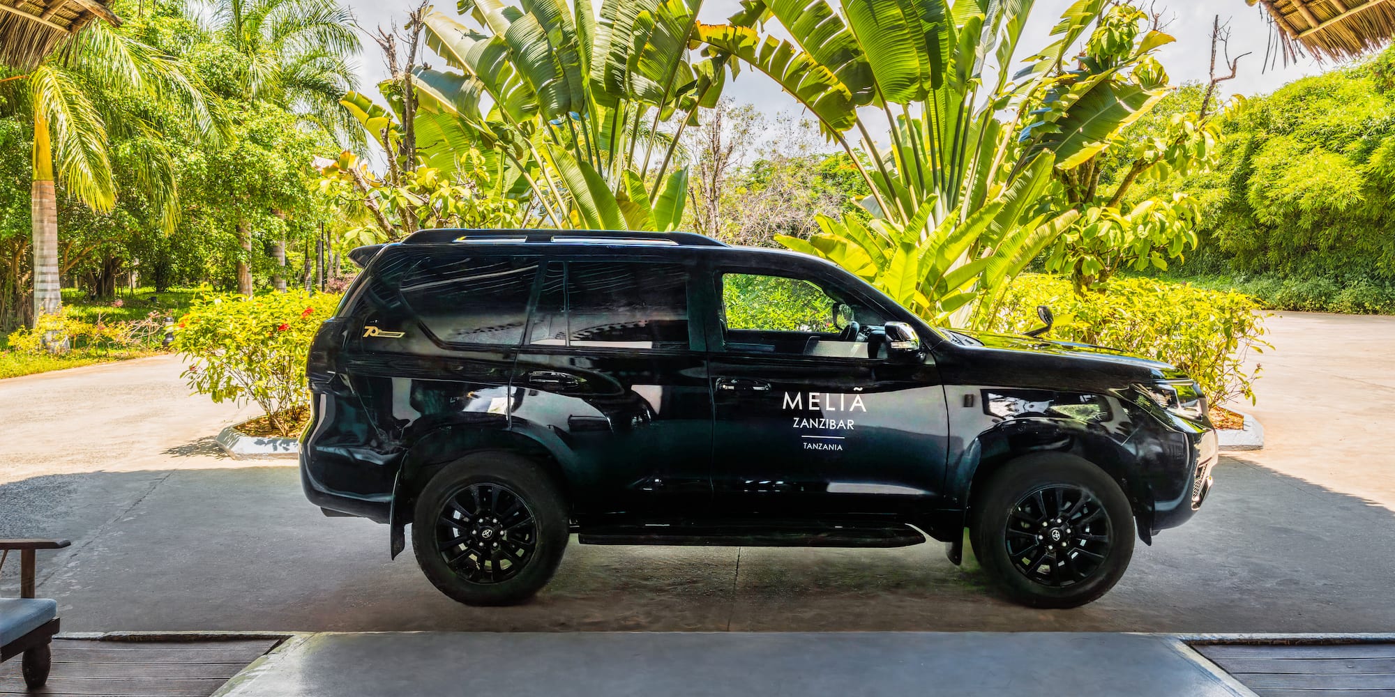 Black Meliá Zanzibar SUV shuttle at a tropical resort in Tanzania.
