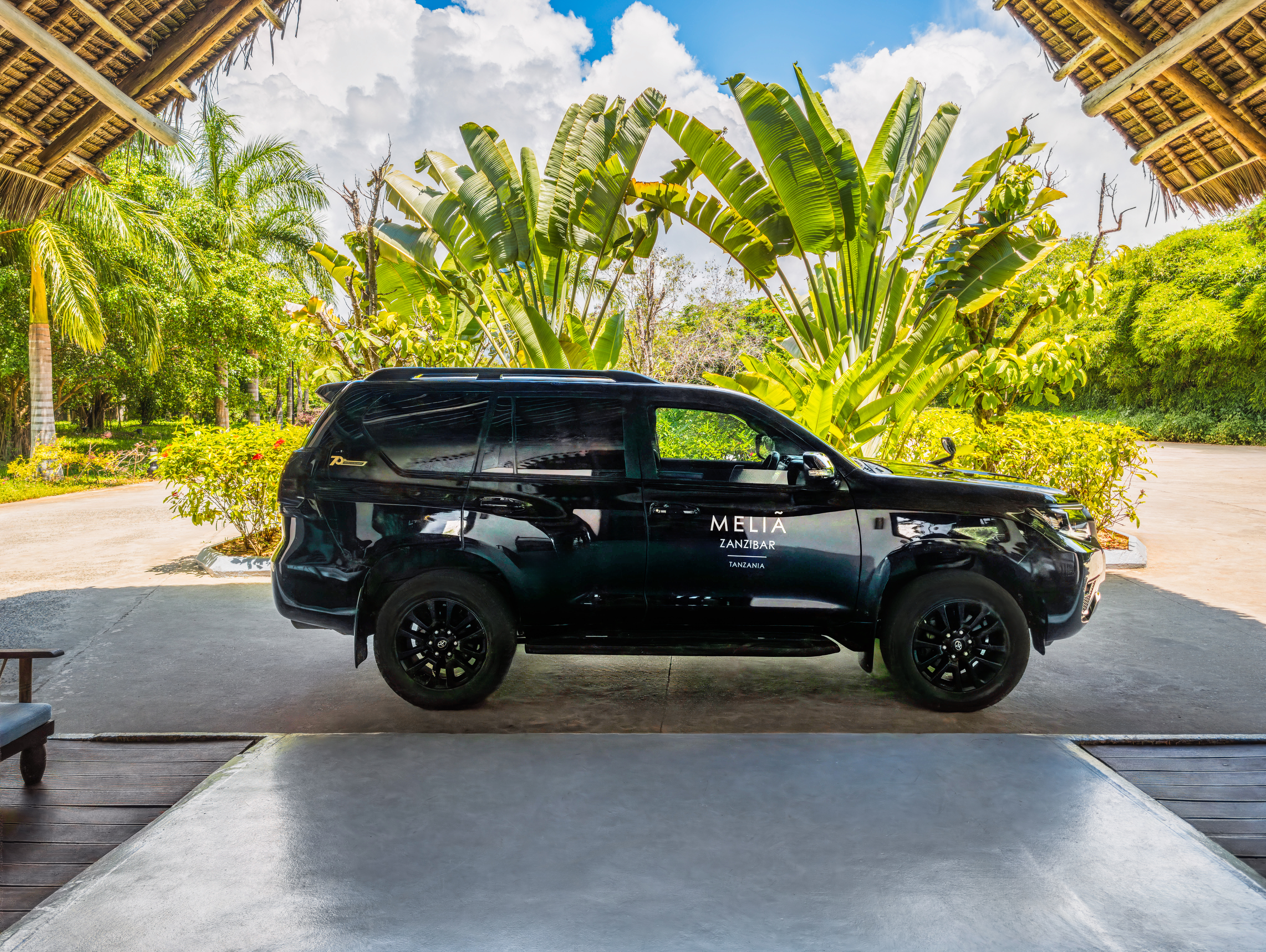 Black Meliá Zanzibar SUV shuttle at a tropical resort in Tanzania.