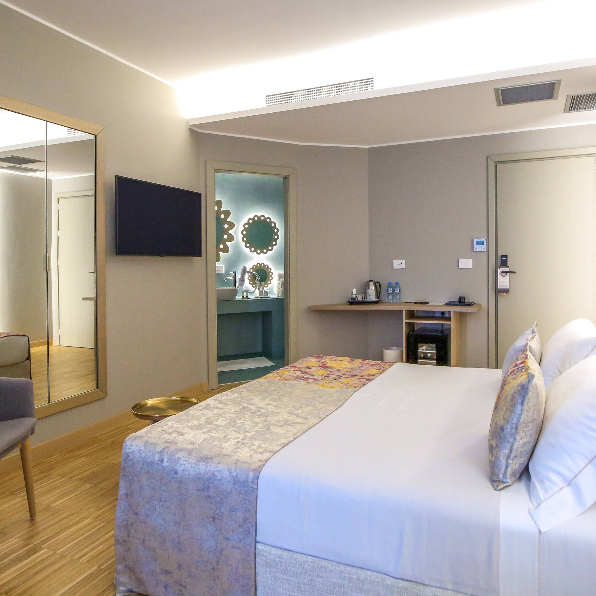 a room with a bed and a mirror