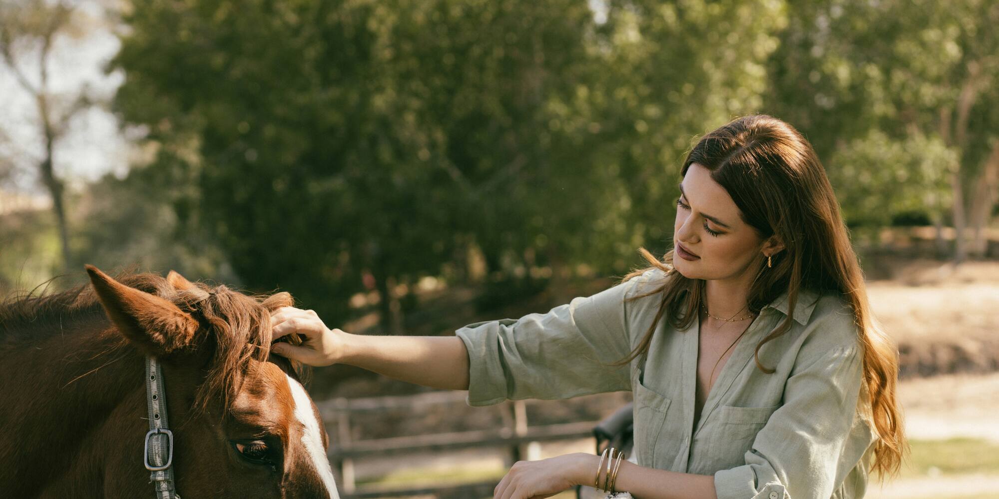a woman petting a horse
