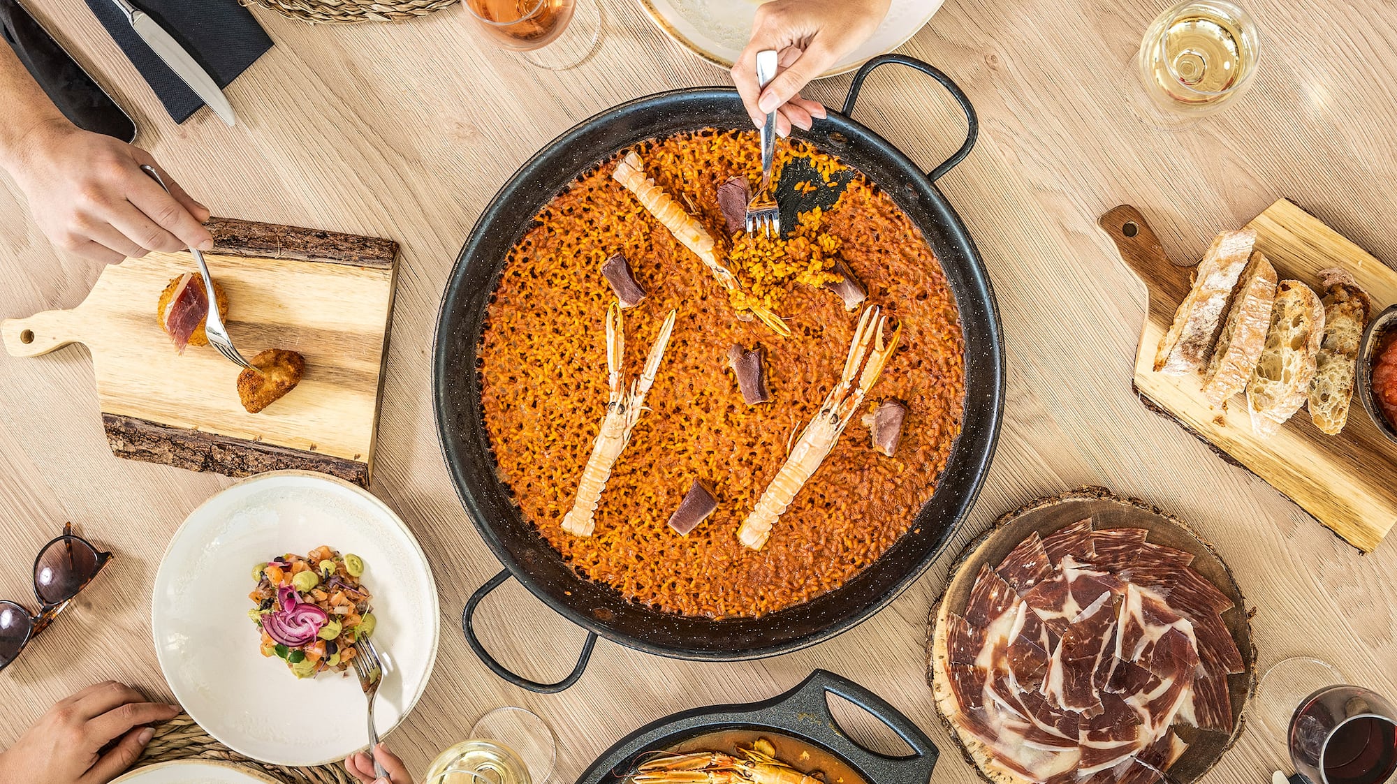 a group of people eating food around a table