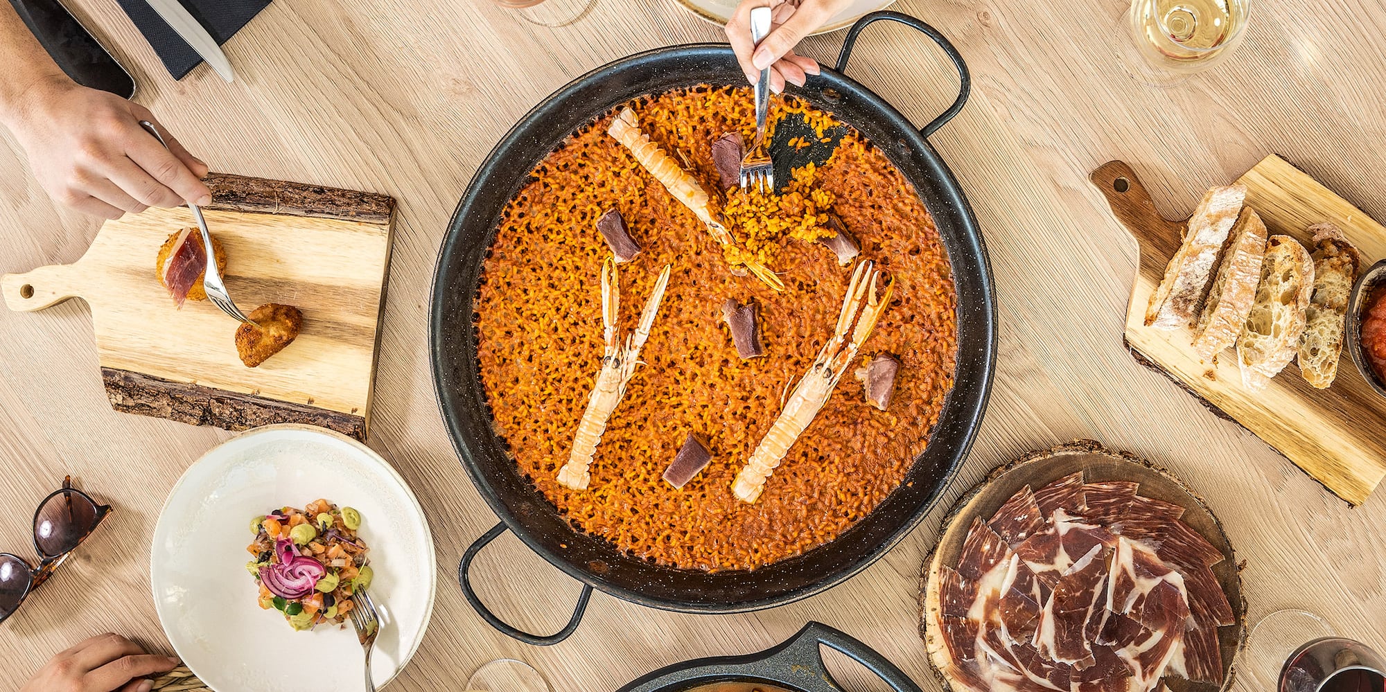 a group of people eating food around a table