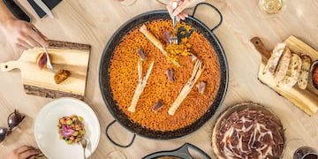 a group of people eating food around a table
