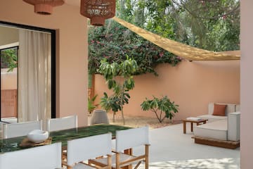 a patio with a table and chairs