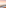 Rooftop terrace overlooking a sandy beach and ocean at sunset.