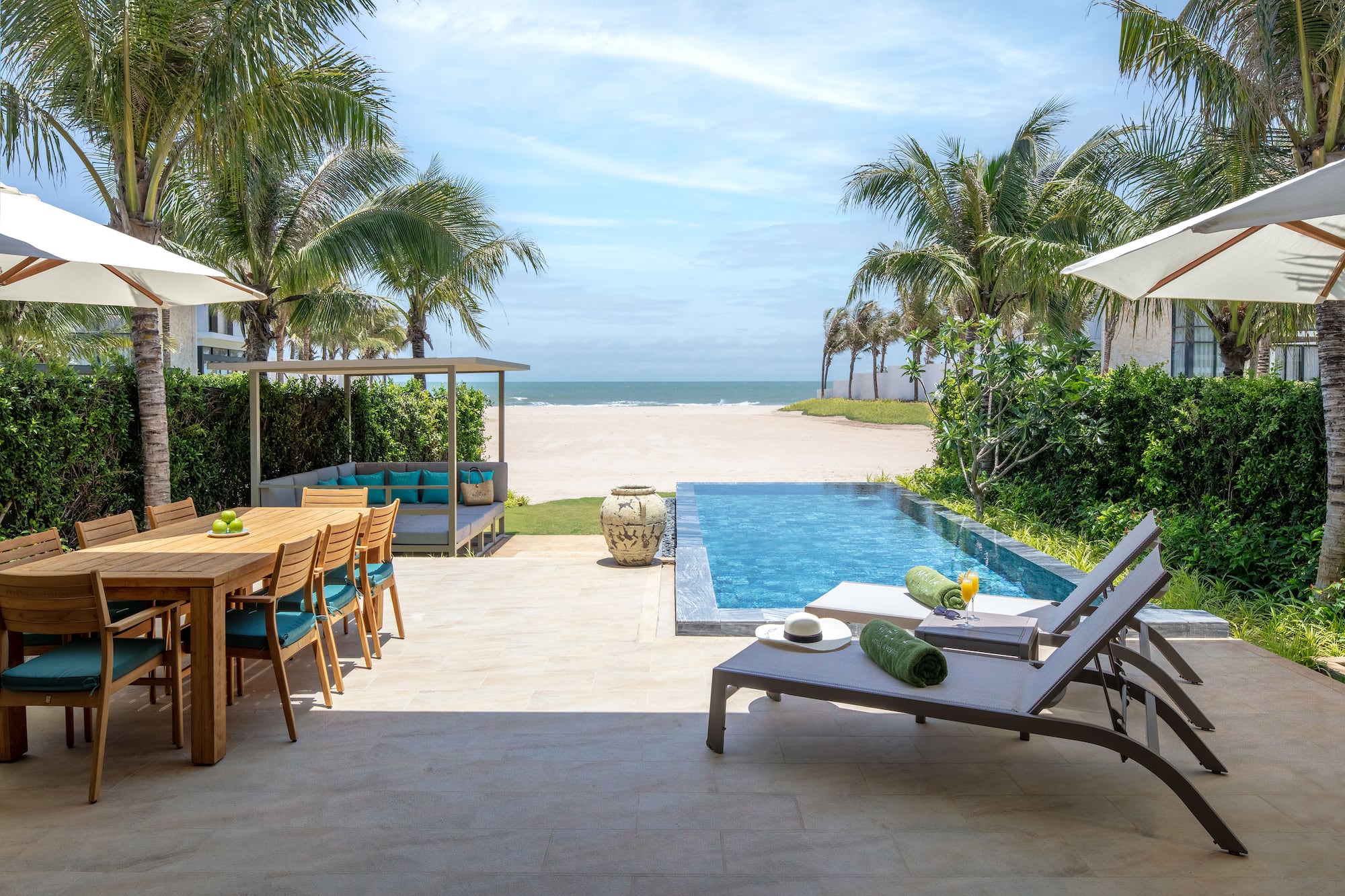 Beachfront villa with private pool, outdoor dining, patio, and ocean.