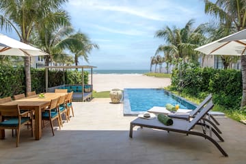 a pool with chairs and a table on it