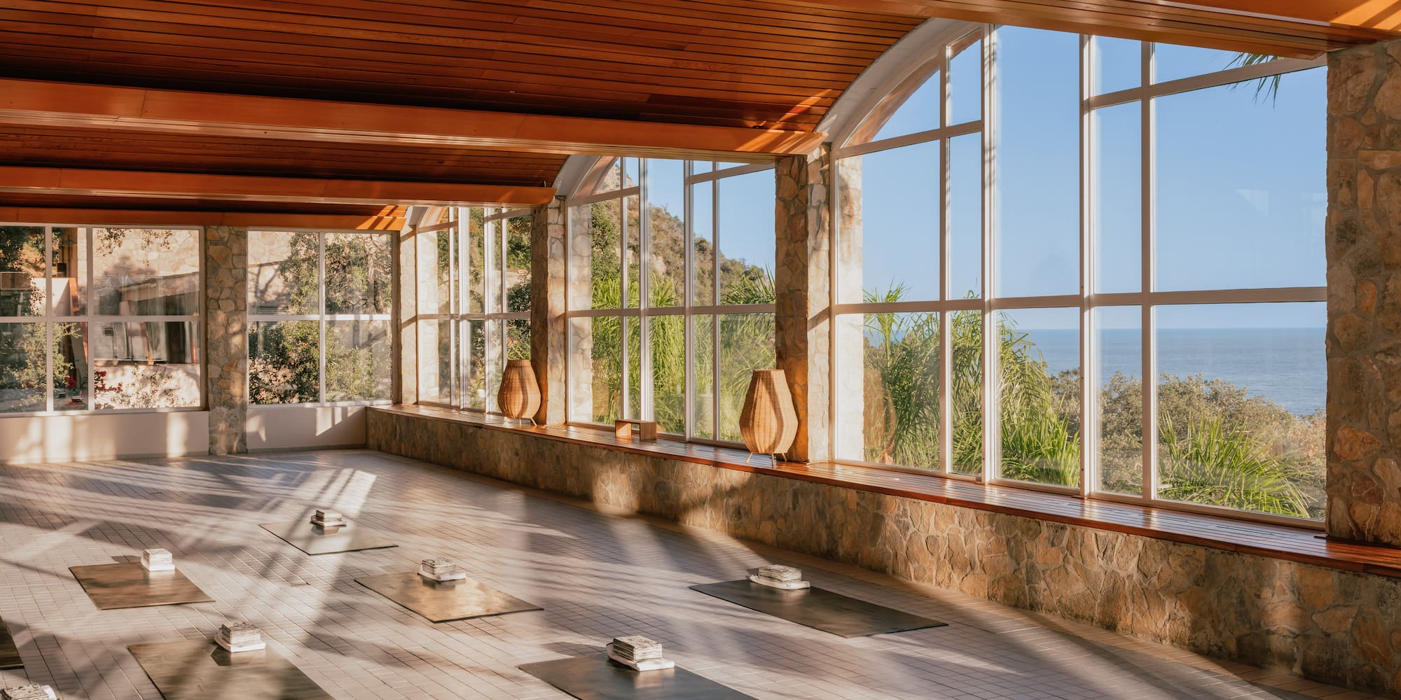 a large room with mats and a large window